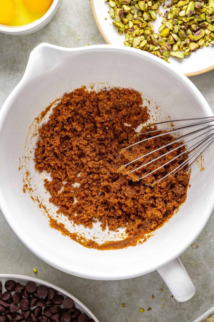 Whisking coconut sugar and avocado oil to start pistachio brownie batter