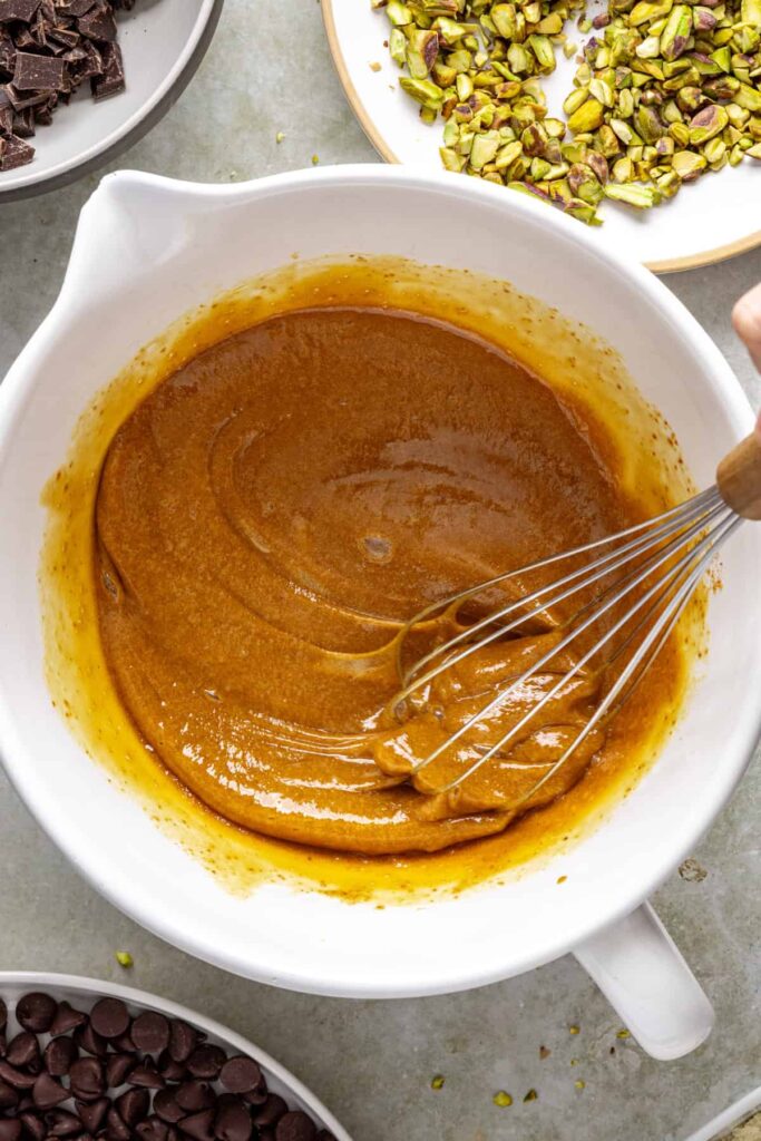 Whisking eggs into coconut sugar mixture for gluten-free brownies