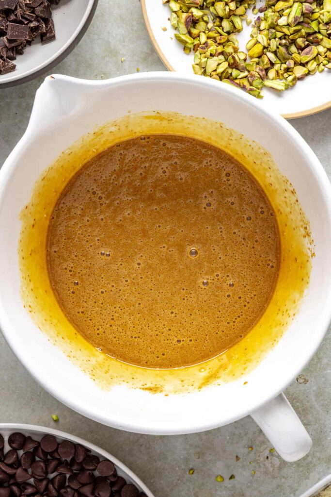 Eggs whisked into brownie batter to create shiny crust pistachio brownies