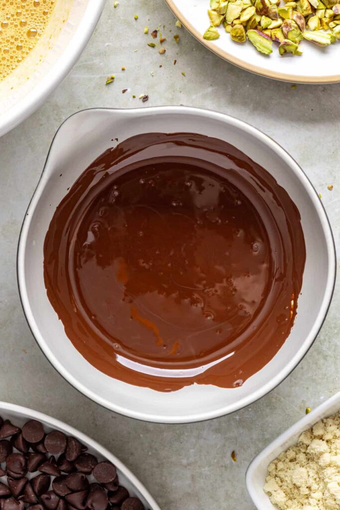 Melted dark chocolate in bowl for pistachio brownie batter