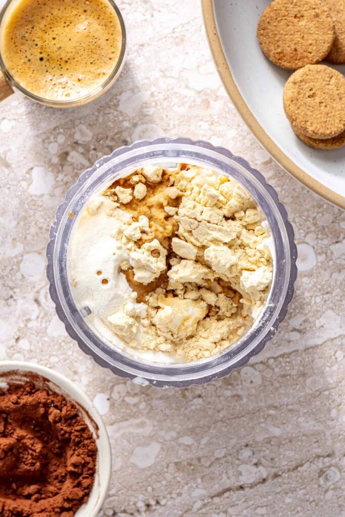 Cottage cheese, yogurt, and protein powder in blender for tiramisu cups