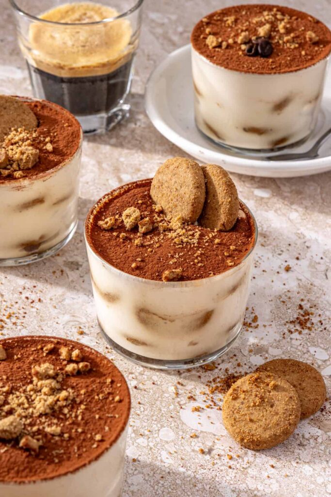 High-protein tiramisu cups served with espresso on a set table
