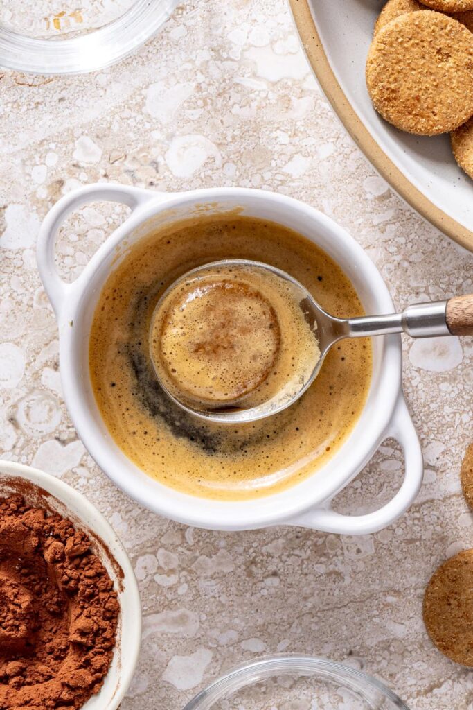 Dipping gluten-free cookies into espresso for tiramisu cups