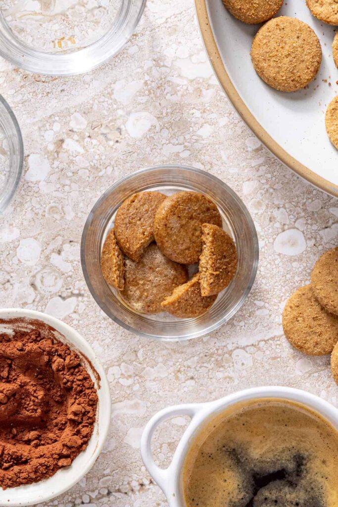 First layer of espresso-soaked cookies in tiramisu cups