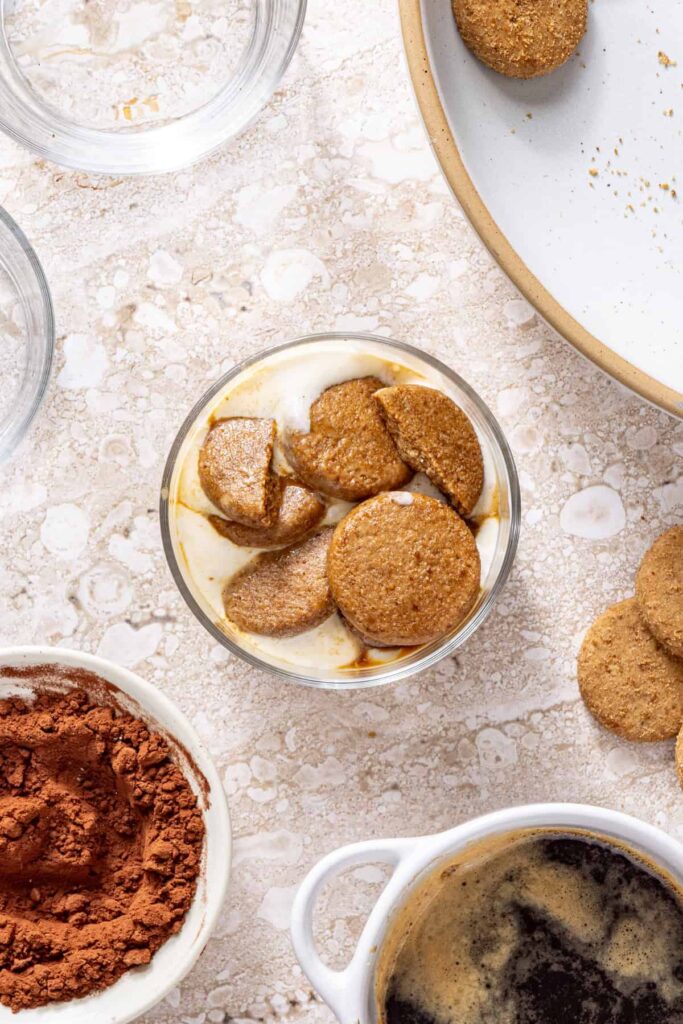 Adding second layer of espresso-soaked cookies to tiramisu