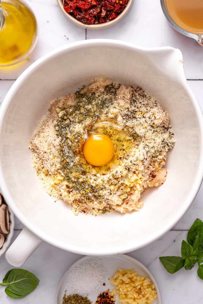 Bowl of seasoned ground chicken mixture for marry me chicken meatballs recipe