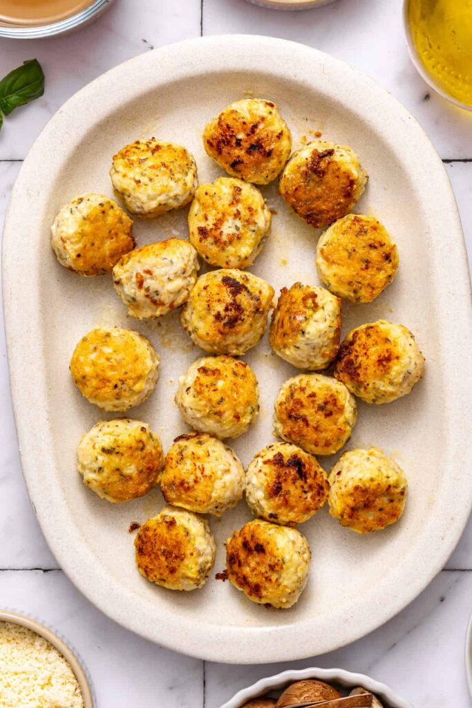 marry me chicken meatballs cooked and resting on a serving tray before going back in skillet