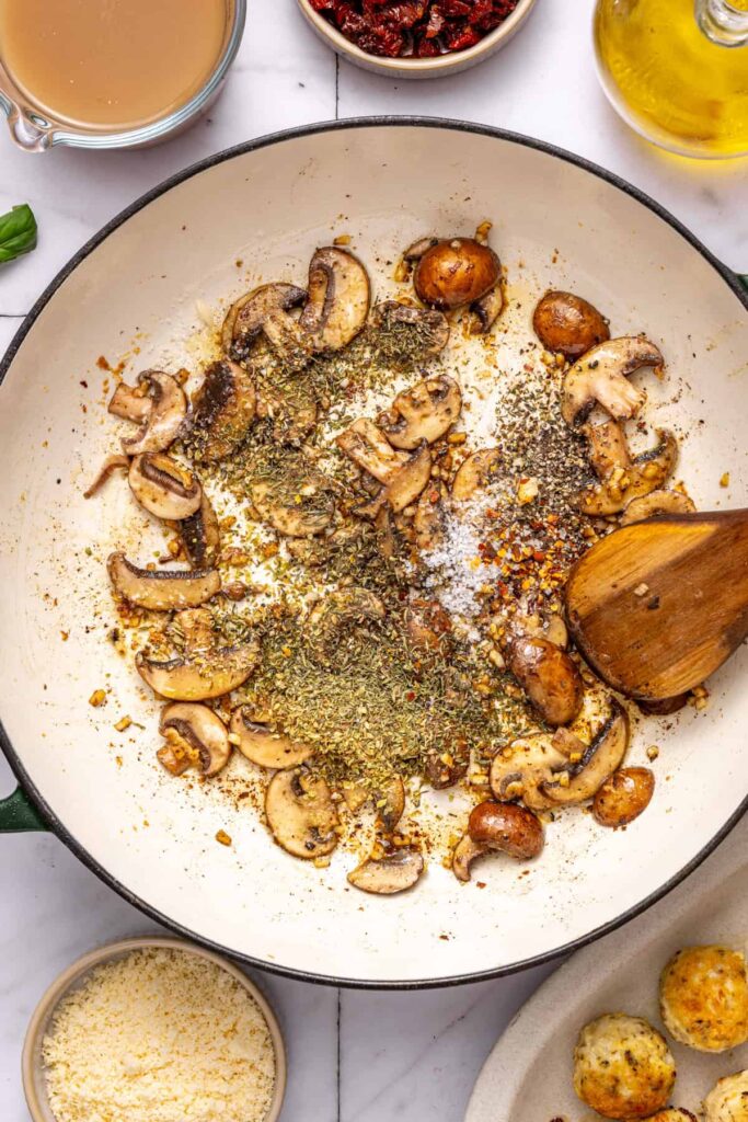 Adding dried herbs and spices to skillet for marry me chicken meatballs