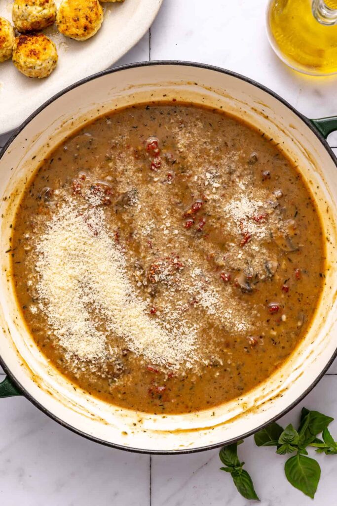 Adding Parmesan to sauce for rich chicken meatballs