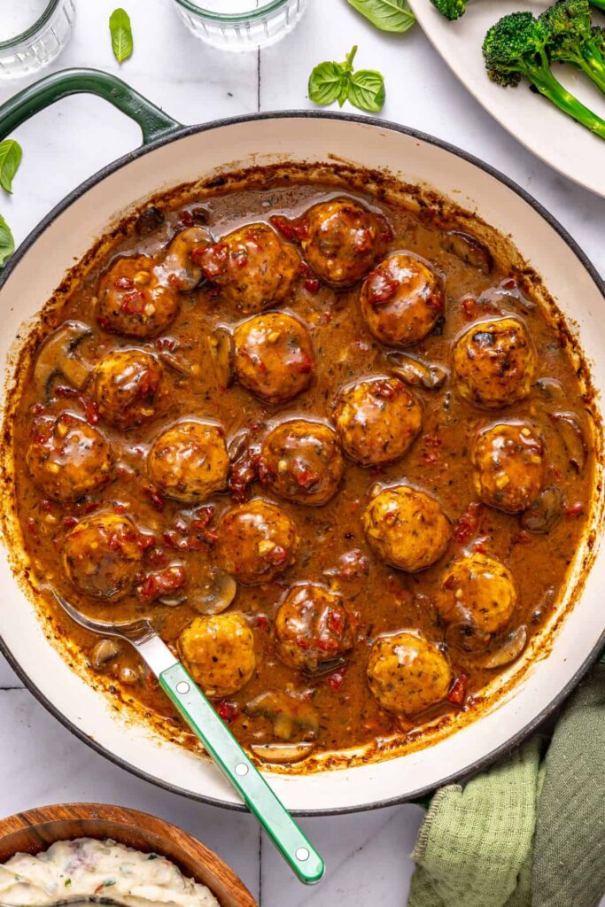 Overhead shot of marry me chicken meatballs in creamy sauce in skillet