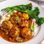 Marry me chicken meatballs served with mashed potatoes and broccolini on plate
