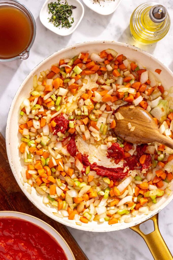 Garlic and tomato paste cooking with vegetables for short rib ragu