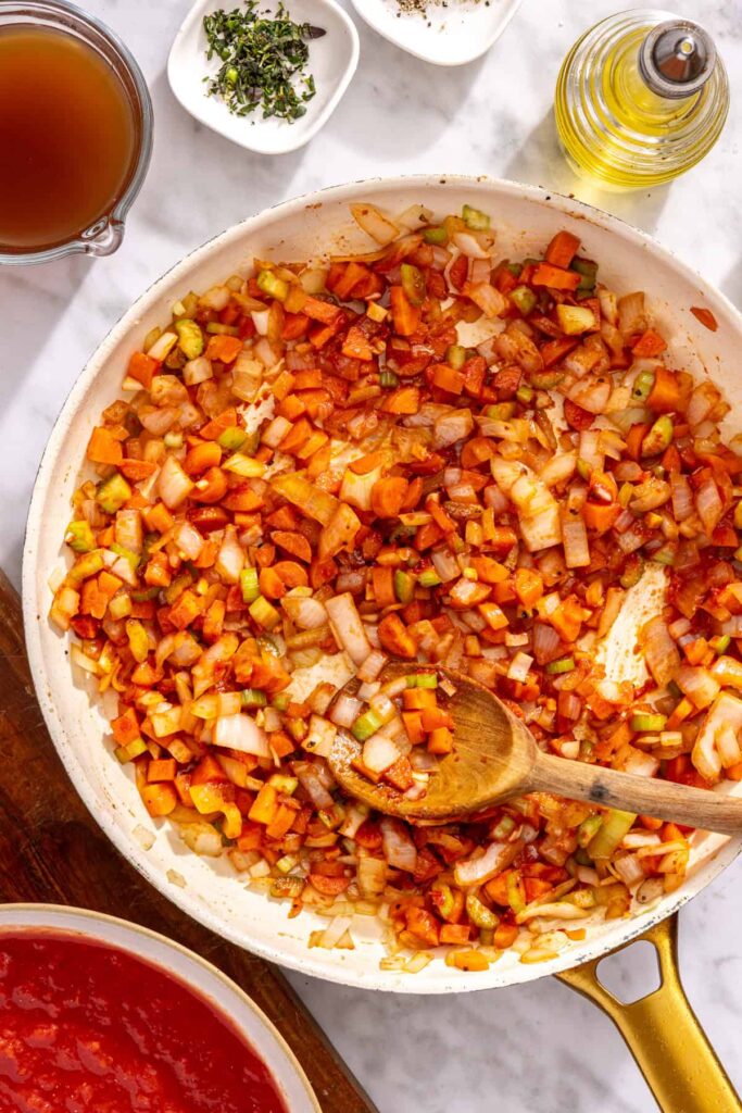 Tomato paste and garlic sautéed until fragrant for ragu sauce