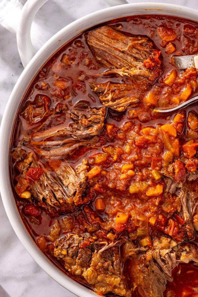 Close-up of juicy shredded beef in ragu sauce