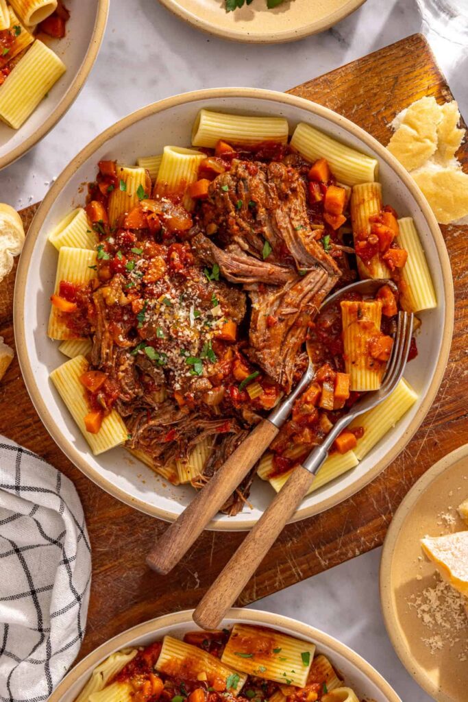 Healthy slow cooker short rib ragu served over noodles