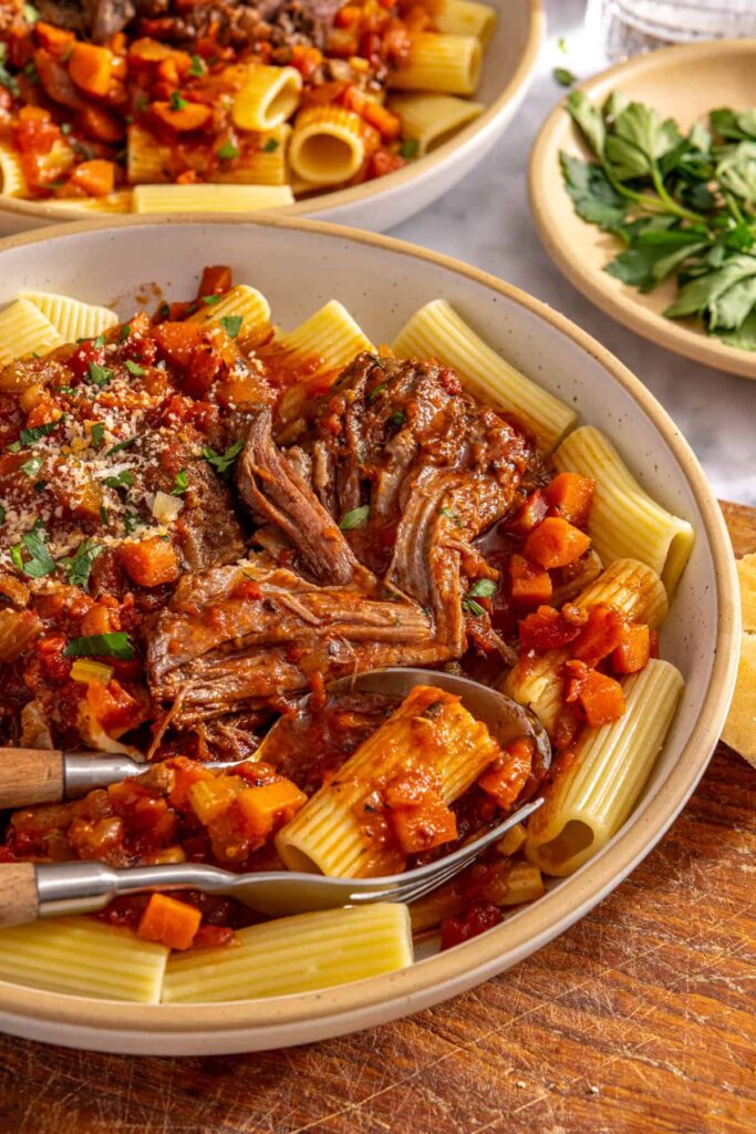 Detailed view of shredded beef short rib ragu on pasta