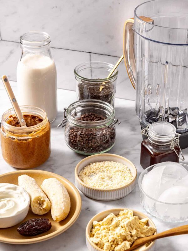 Healthy dessert smoothie ingredients including frozen banana, chia seeds, and coconut flakes