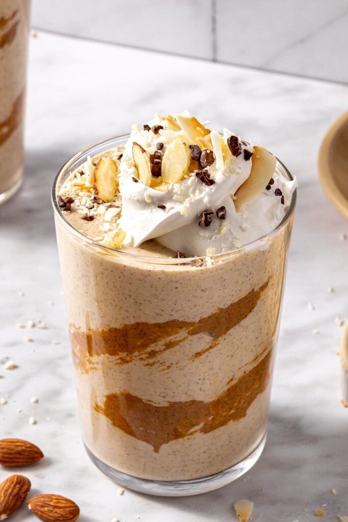 Close-up of almond joy smoothie with rich chocolate coconut toppings in a glass