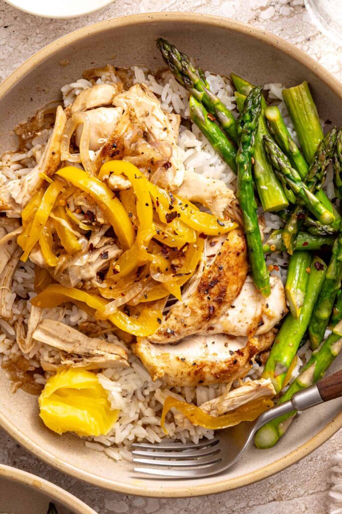 Detailed shot of chicken thigh rice bowl with ghee melting on top