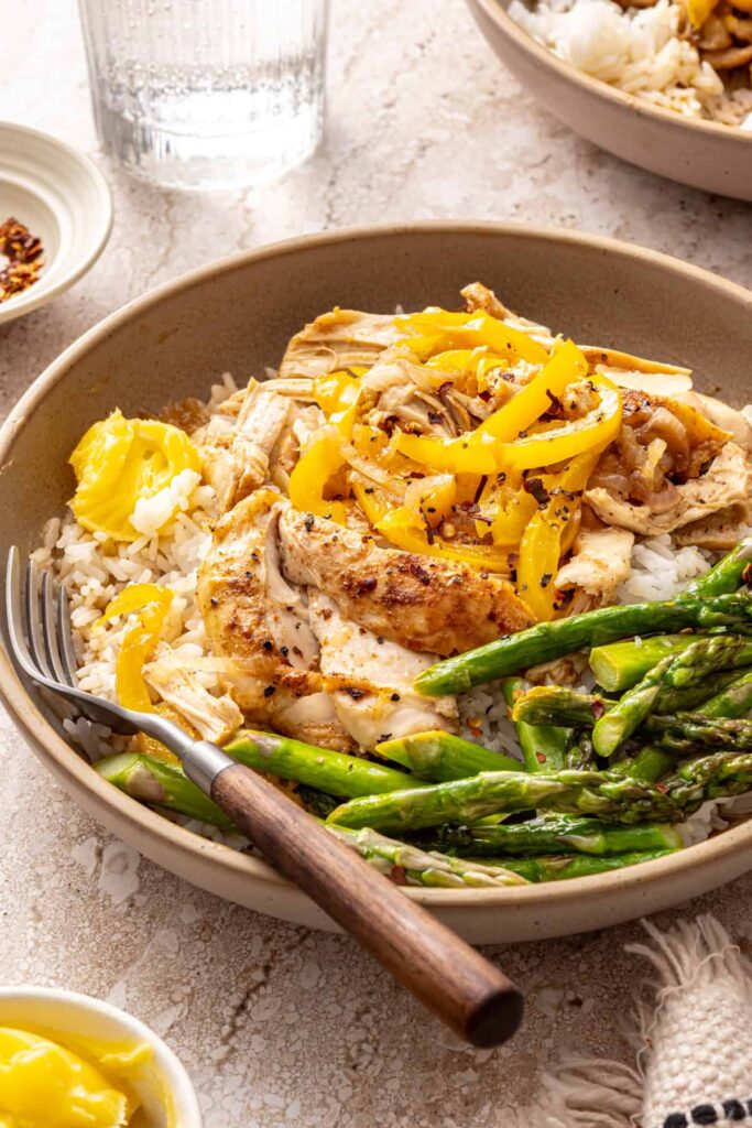 Angled shot of healthy chicken thigh rice bowl with toppings