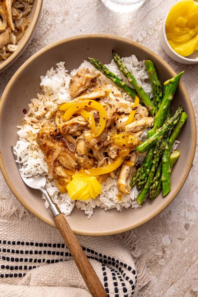 Overhead view of cozy chicken thigh rice bowl on a styled table