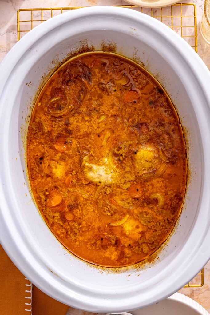 crockpot chicken curry and vegetables after cooking, ready to shred