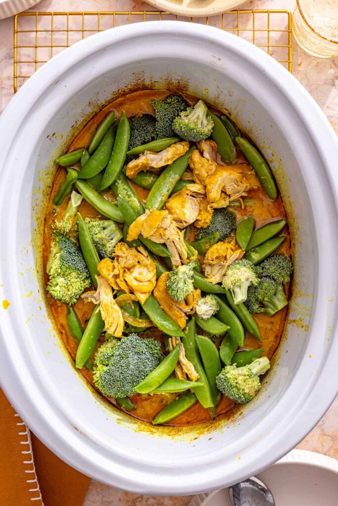 adding broccoli and snap peas to slow cooker chicken curry