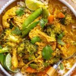 crockpot chicken curry over basmati rice, close-up overhead shot with spoon