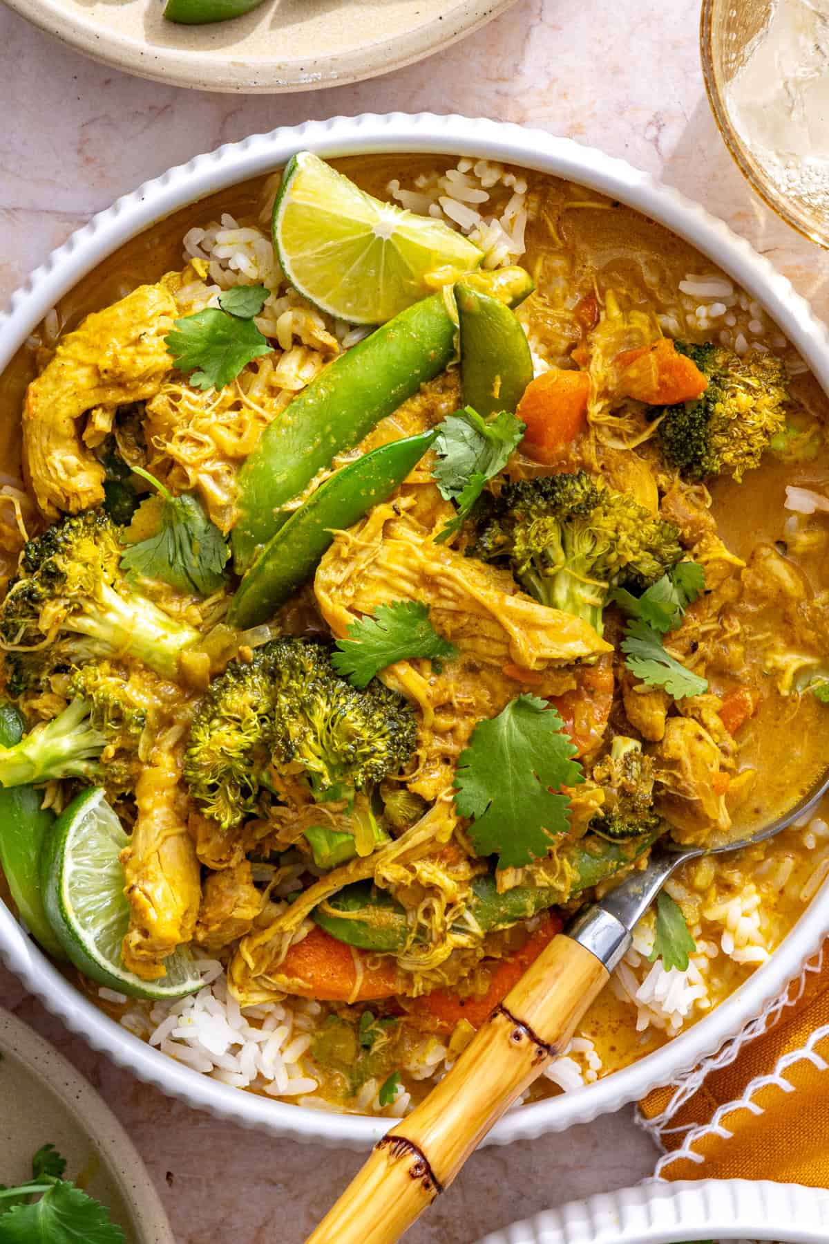 crockpot chicken curry over basmati rice, close-up overhead shot with spoon