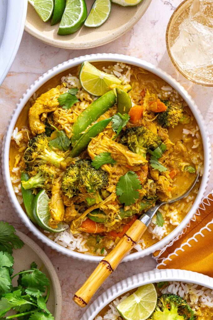slow cooker chicken curry served over rice with cilantro garnish