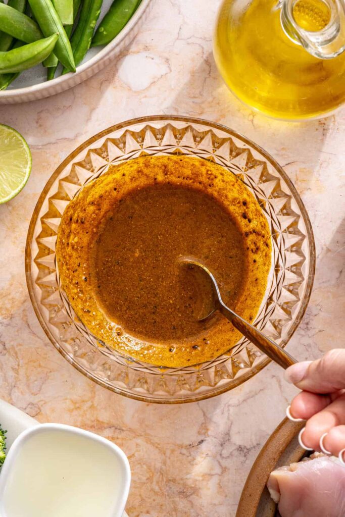 spice blend being mixed into paste for crockpot chicken curry