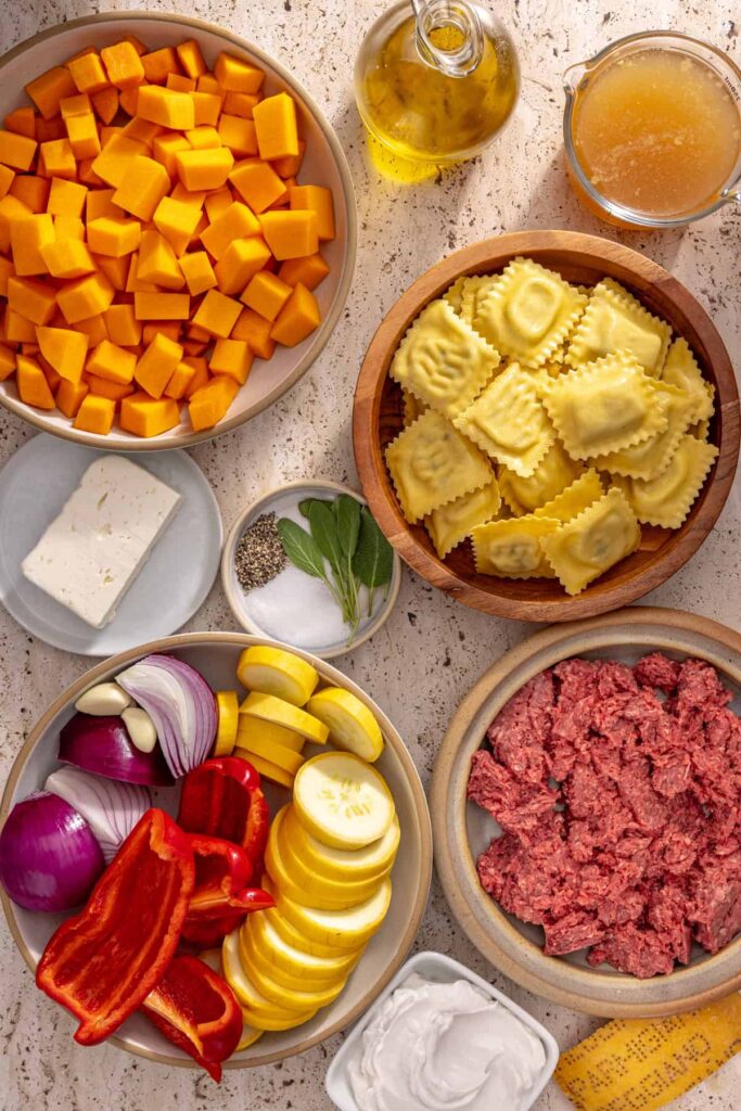 Raw ingredients for high-protein butternut squash ravioli including squash, beef, and feta