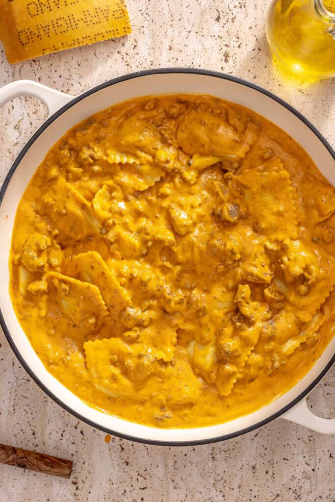 Finished ravioli with hidden veggie sauce in pan