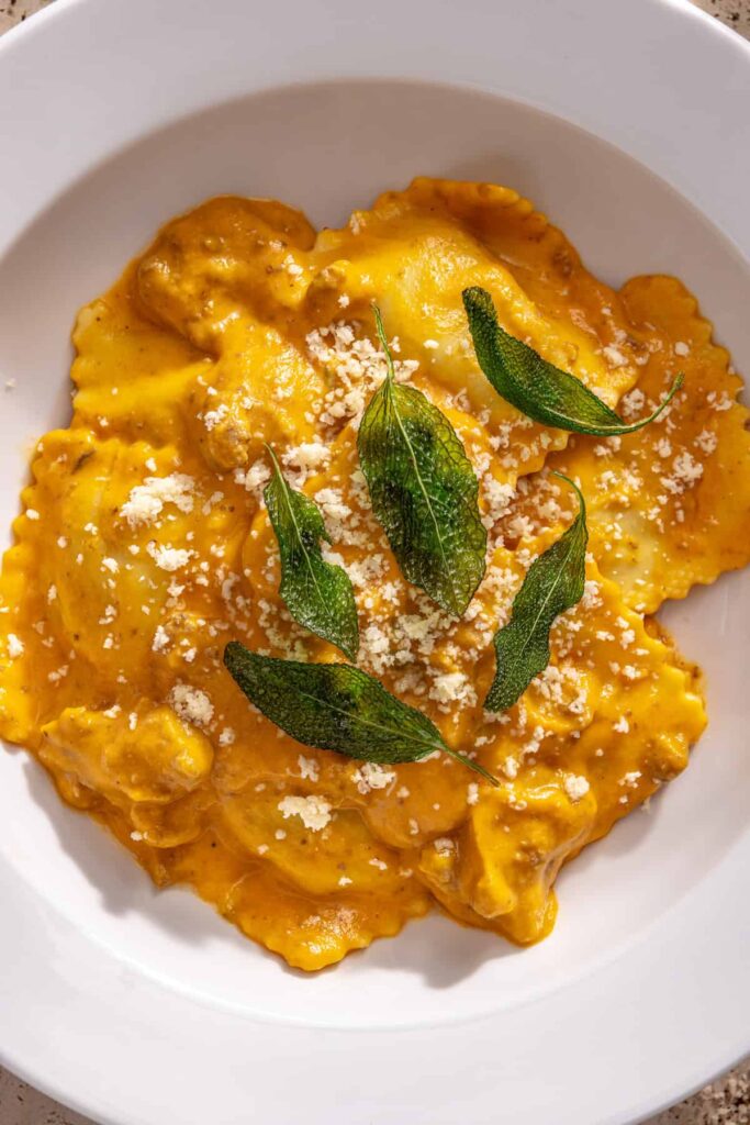 Close-up of butternut squash ravioli with parmesan and fried sage