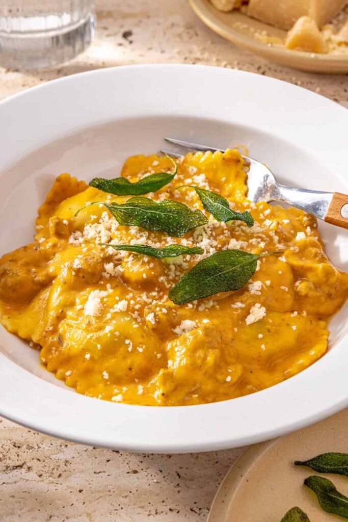 Creamy ravioli with hidden veggie sauce in bowl side view