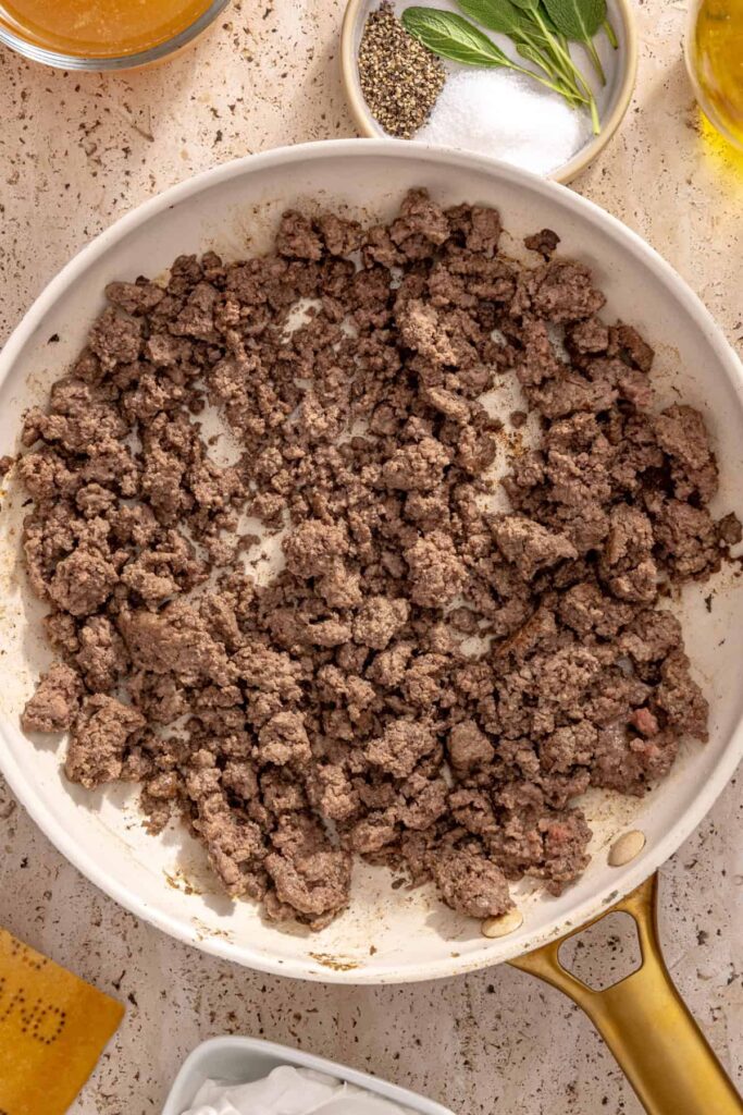 Ground beef cooking in pan for protein-packed ravioli