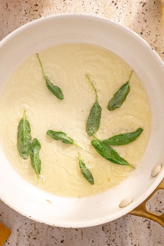 Fresh sage leaves crisping in pan for ravioli topping