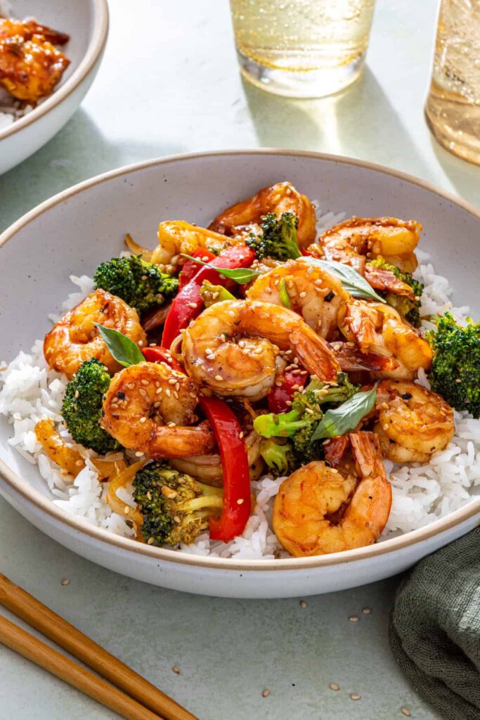 easy shrimp and veggie stir fry served over rice on a table