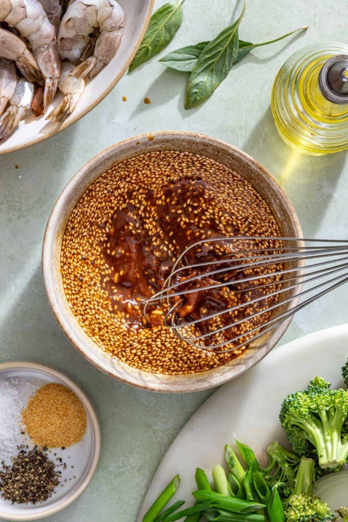 Whisking homemade stir fry sauce with coconut aminos, honey, garlic, and ginger
