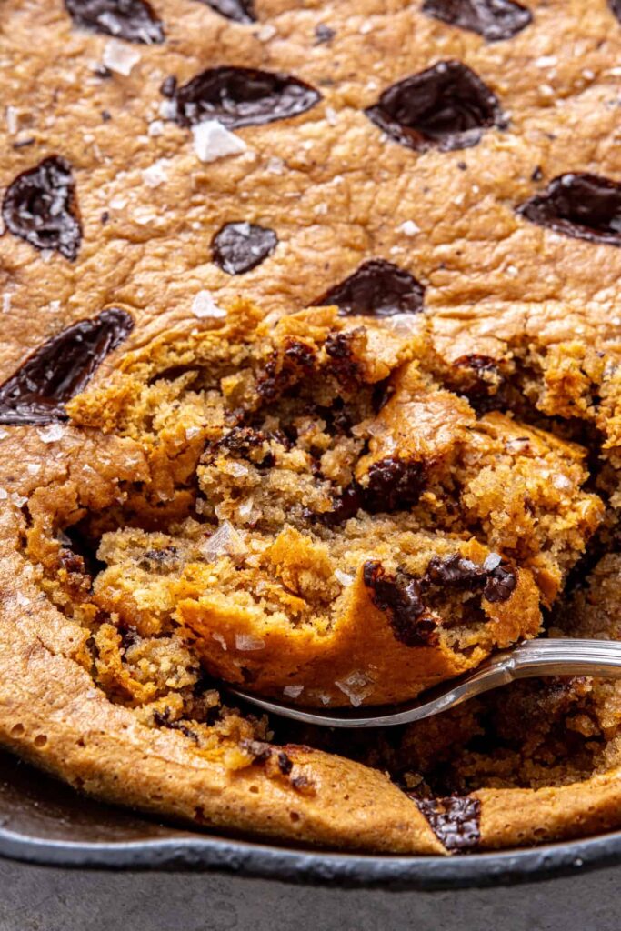 tight close-up shot of warm and gooey chocolate chip cookie skillet