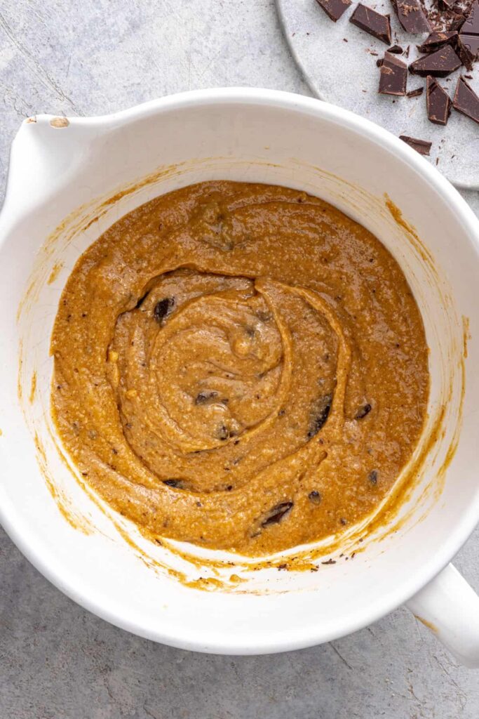 Dark chocolate chips mixed into gluten-free cookie skillet batter