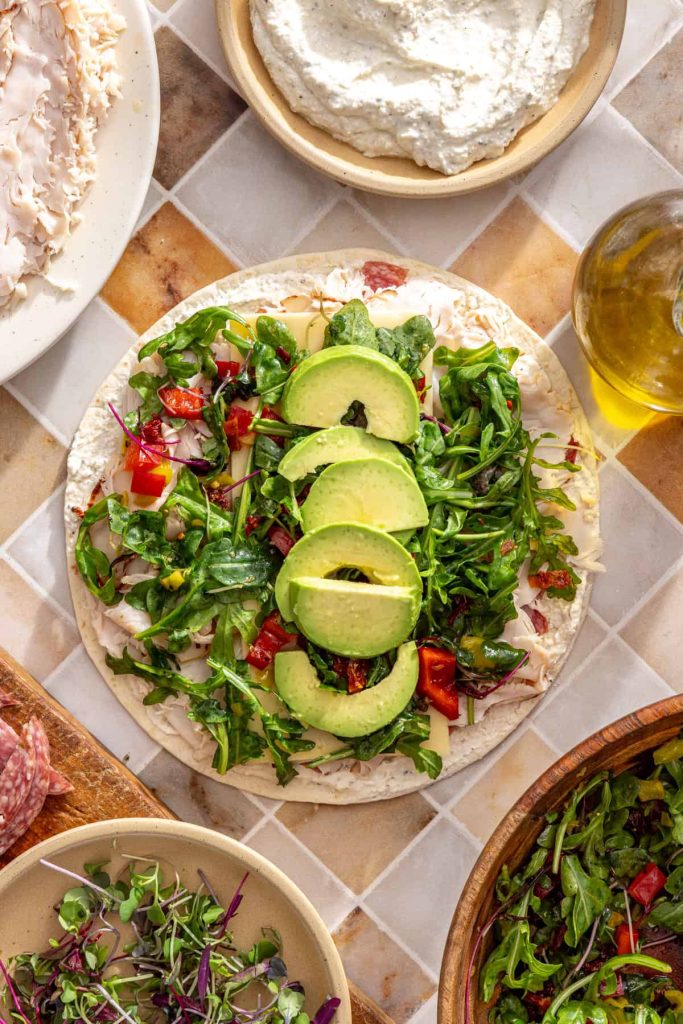 Avocado slices added down the center of turkey wrap