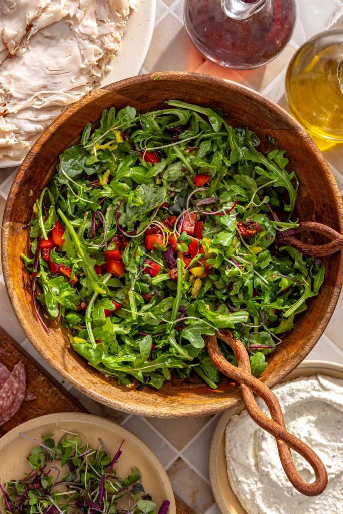 Arugula, peppers, microgreens, and sundried tomatoes tossed together