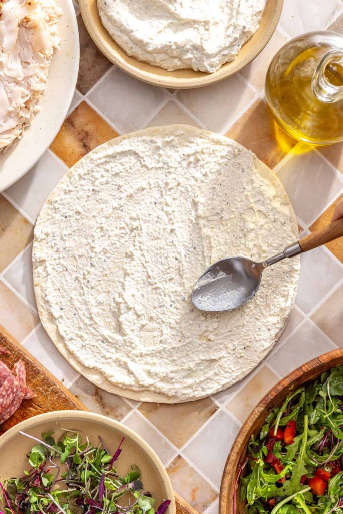 Spreading cottage cheese mixture evenly over a cassava tortilla
