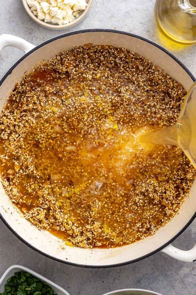 Lemon juice and chicken stock added to quinoa pilaf mixture