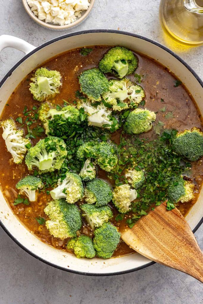 Lemon herb chicken quinoa skillet with broccoli florets before baking