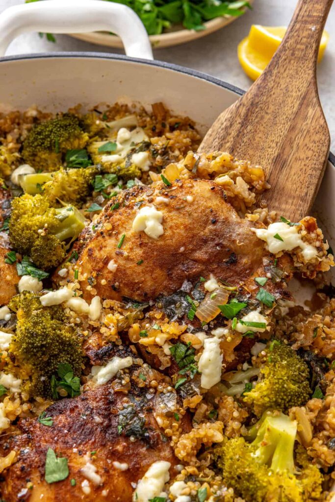Side angle close-up of lemon herb chicken quinoa pilaf in a skillet