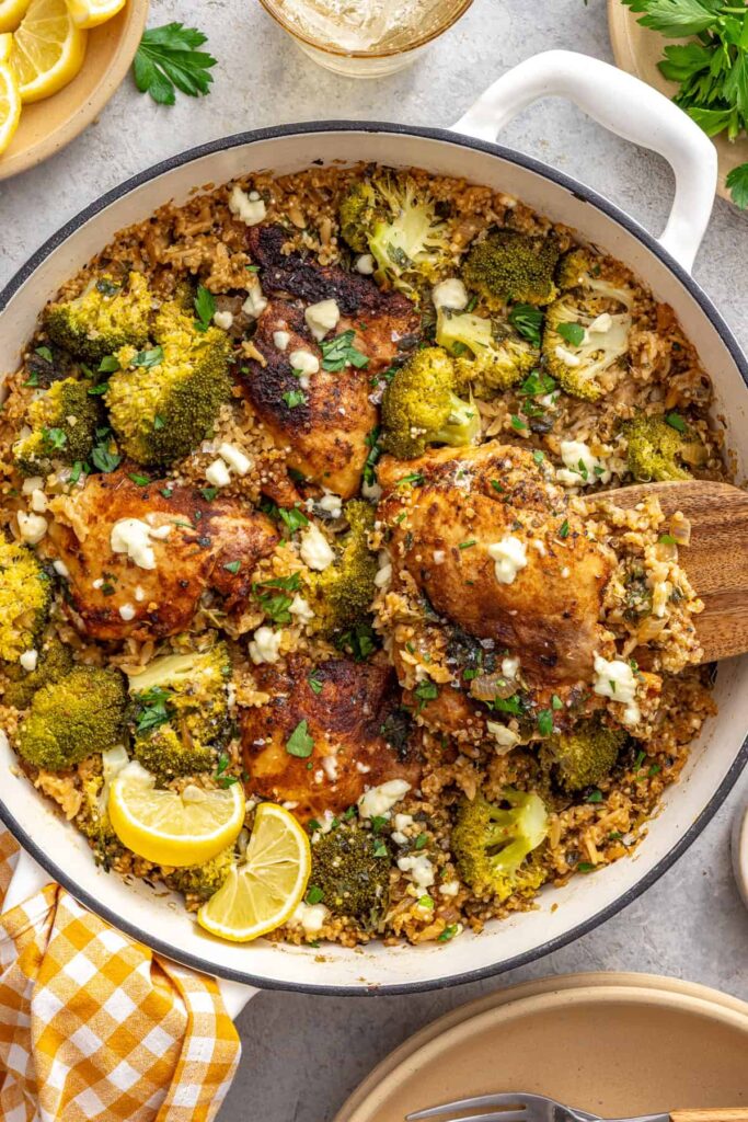 Lemon herb chicken quinoa pilaf garnished with parsley and lemon