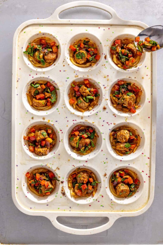Adding sautéed vegetable and sausage filling into baked potato crusts for gluten-free quiche cups