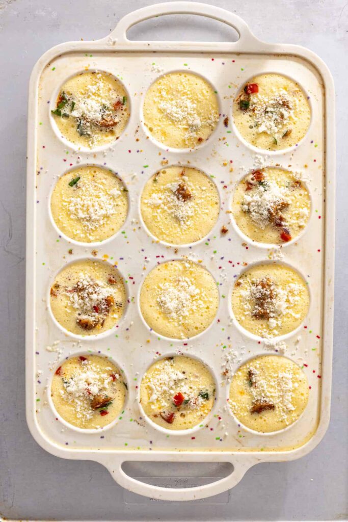 Assembling gluten-free quiche cups before baking with egg mixture poured into molds